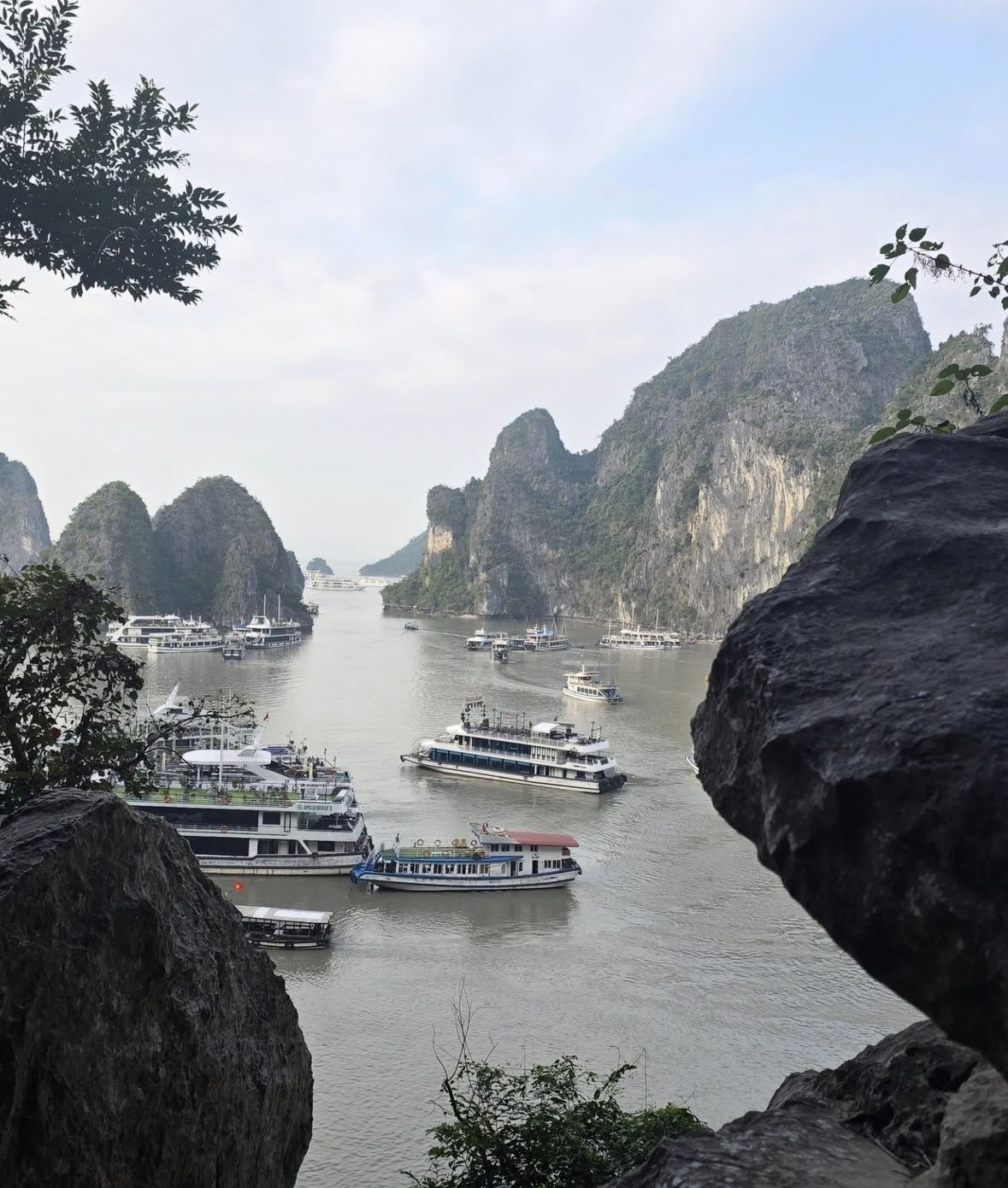 Traditional wooden junk boat departing Tuan Chau Marina in Ha Long Bay